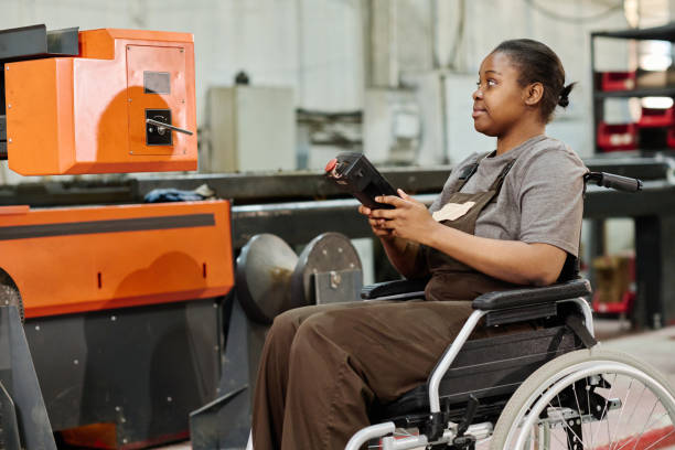 istock Worker with disability in factory on the machine 1408192033