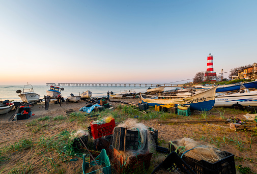 Shabla , Bulgaria - 7 may, 2022: Lighthouse and fishing boat marina at sunrise, near Shabla town. Bulgaria, Europe.