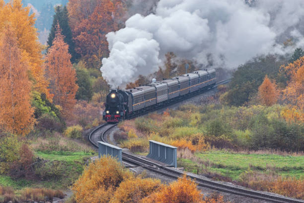 istock Retro steam train at autumn morning. 1408196595