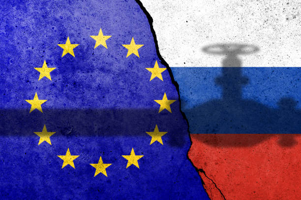 Flag of Europe Union and Russia painted on a concrete wall with gas pipe shadow. Relationship between EU and Russia stock photo