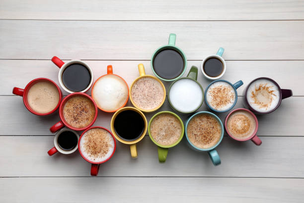 istock Many different cups with aromatic hot coffee on white wooden table, flat lay 1408199091