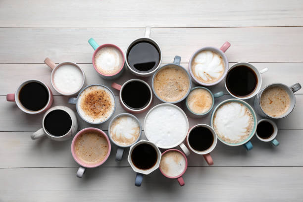 istock Many different cups with aromatic hot coffee on white wooden table, flat lay 1408199100