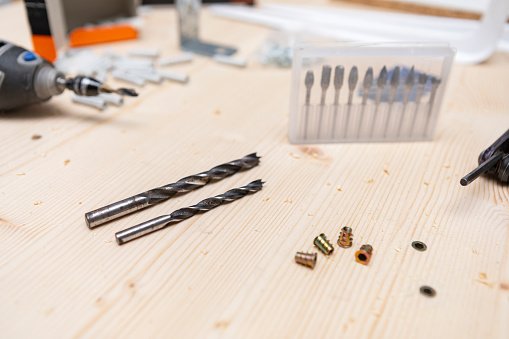 Screws and other wood tools on pine raw wood.