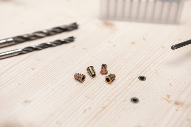 Screws and other wood tools on pine raw wood.