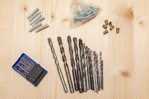 Screws and other wood tools on pine raw wood.