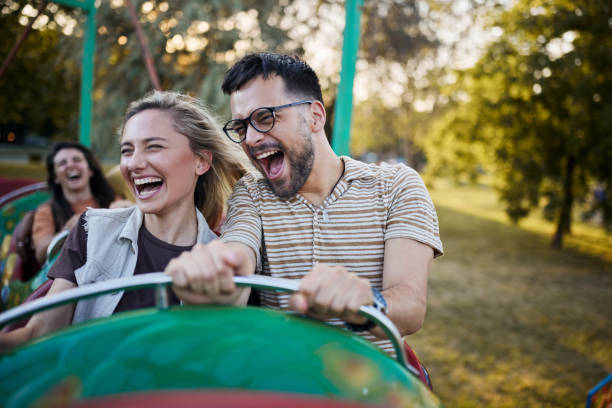 istock Cheerful couple having fun on rollercoaster at amusement park. 1408199997