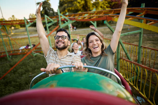 istock Young carefree couple having fun on rollercoaster ride at amusement park. 1408200535