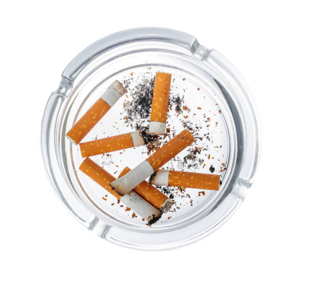 istock Burnt cigarette butts in an ash tray isolated on white 1408200916