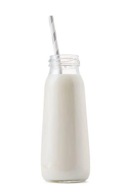 istock Glass cup of milk with a straw isolated on white 1408201443