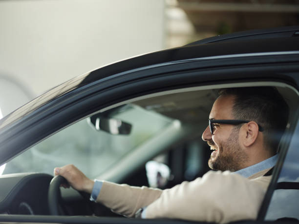 istock Young happy man enjoying while traveling by car. 1408201697