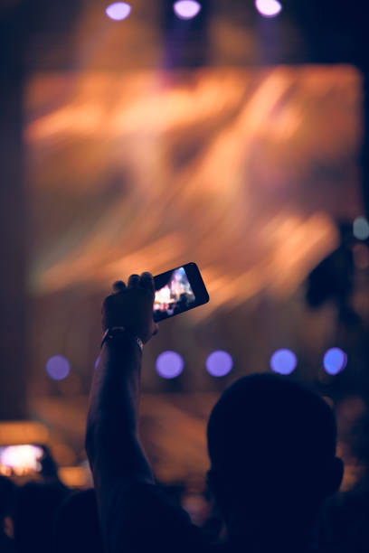 istock Person holding modern smartphone on a concert. 1408202850