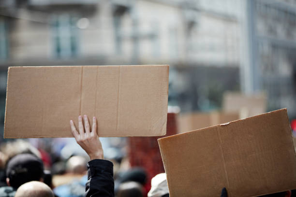 istock Protesters holding placards and signs on the streets. 1408202916