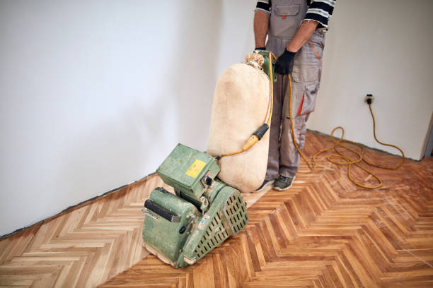 istock Repairman restoring parquet with a sanding machine. 1408202963