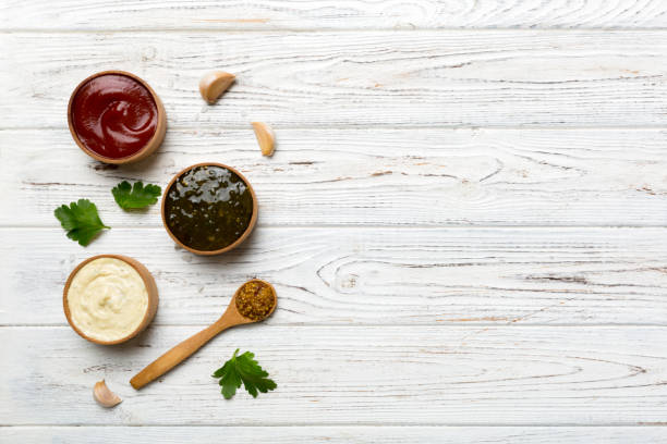 istock Different sauces in spoons on table background, flat lay top view 1408209909