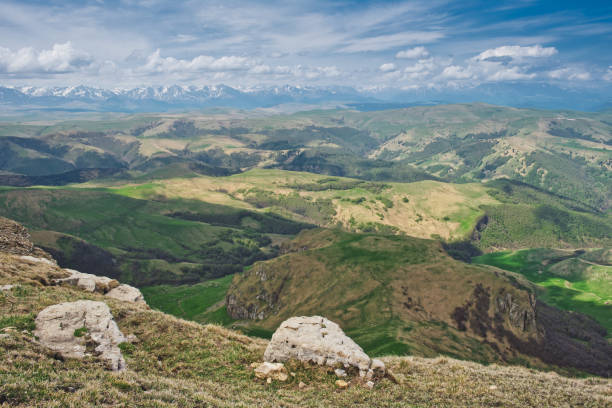 istock Atmospheric alpine landscape with mountain range and green hills under dramatic cloudy sky. 1408211898