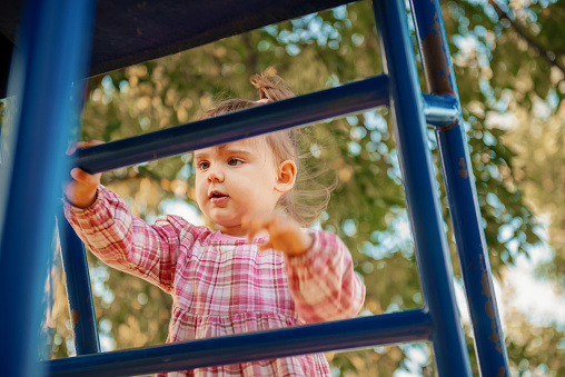 Little girl having fun on playground slide