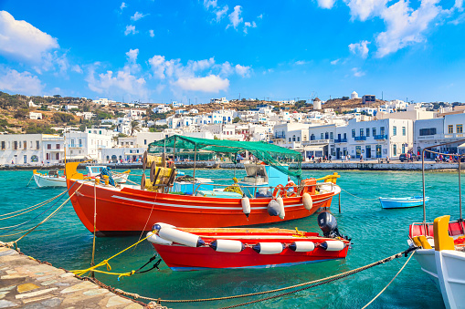 Chora port of Mykonos island with ships, yachts and boats during summer sunny day. Aegean sea, Greece.