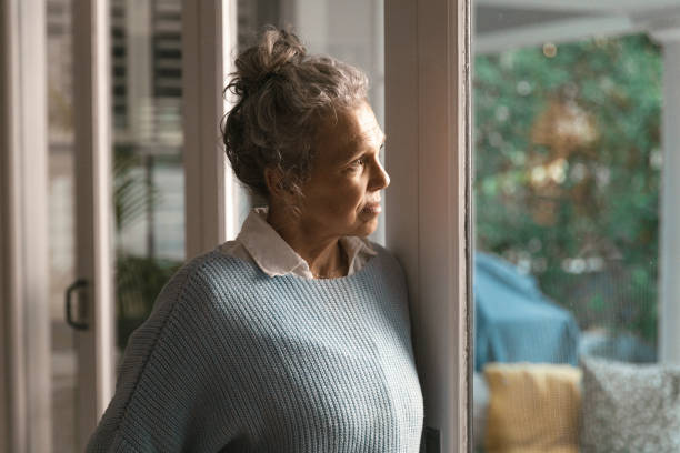 istock Woman looking out of the window 1408215962