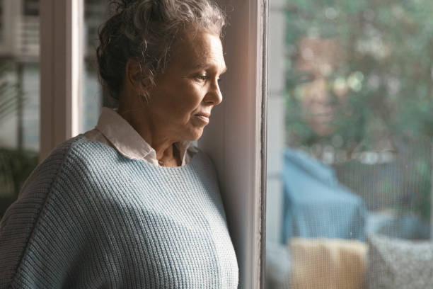istock Woman looking out of the window 1408215982