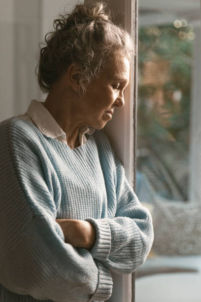 istock Woman standing by the window 1408216072
