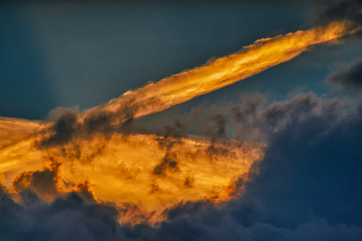 Looking at stunning colored  clouds at sunset. The clouds look like they were painted.