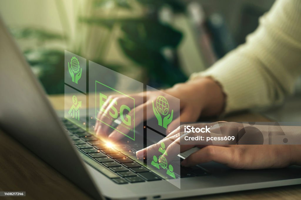 ESG environment social governance investment business concept. Women use a computer to analyze ESG, surrounded by ESG icons .close to the computer screen in business investment strategy concept. Sustainable Resources Stock Photo