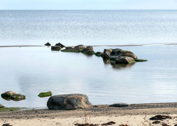 istock a boulder-covered beach, stone silhouettes in the sea 1408217478