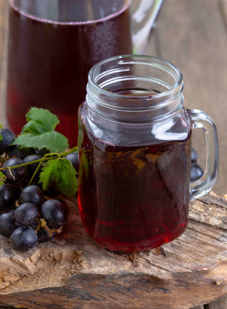 istock Glass of grape juice with fresh grapes 1408217530