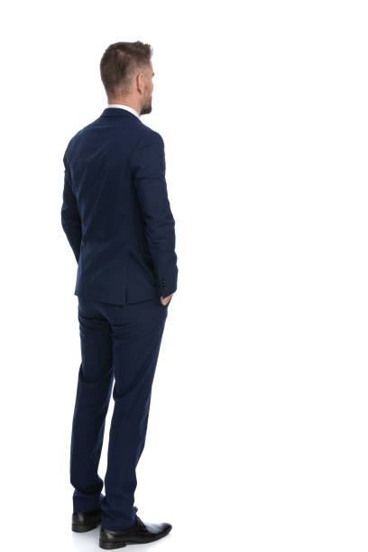 businessman waiting in line with his hands in pockets - businessman one man only standing elegance imagens e fotografias de stock
