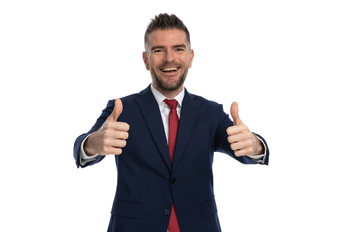 handsome businessman giving a thumbs up with both hands and smiling wide at the camera