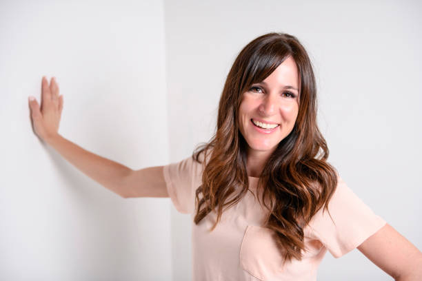istock Happy carefree woman with joyful expression, smiling while standing in relaxed pose against white background 1408226351