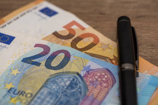 istock Euro banknot standing on wooden table 1408226978