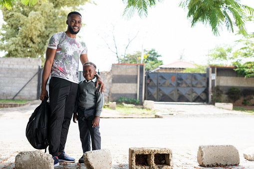 Young father walking son to school