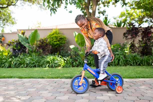 istock Toddler having fun on bicycle with mother at home 1408227185