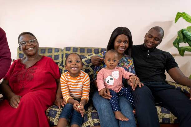 istock Family with young children smiling on couch 1408227476