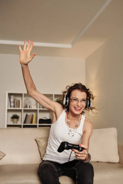 istock Mature Woman Winning in Videogame 1408227750