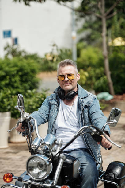 istock Cool Mature Man Sitting on Motorbike 1408227789
