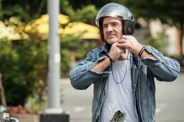 istock Motorcyclist Taking off Helmet 1408227806