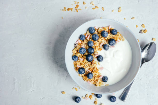 istock Yogurt with muesli and berries on a gray background. 1408229283