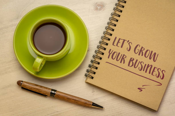 let's grow your busines writing in a notebook stock photo