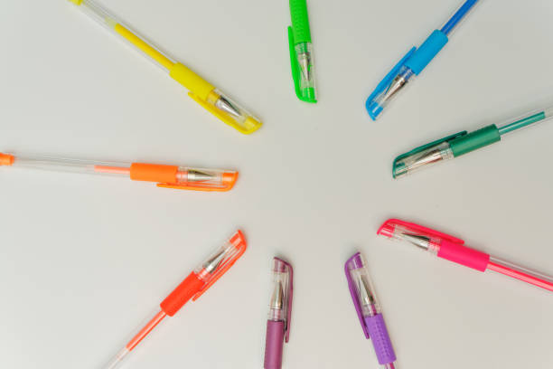 closeup of bunch of colorful pens on white isolated background