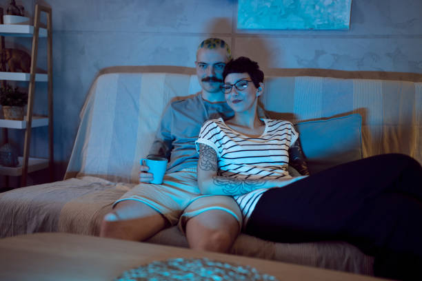 istock At night, young couple watching movie while sitting on the sofa 1408231098