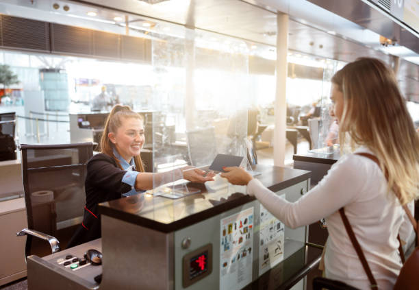 istock Female passenger checking in at airline counter 1408233155
