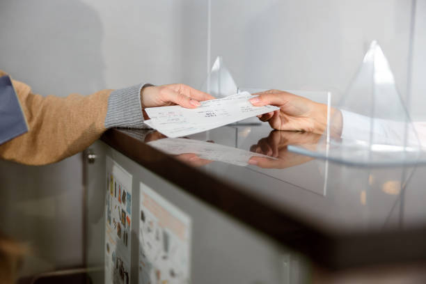istock Close up of airport check-in counters with passengers 1408233166