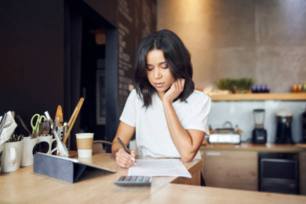istock Unhappy female cafe manager singing documents contract standing behind the counter 1408233968