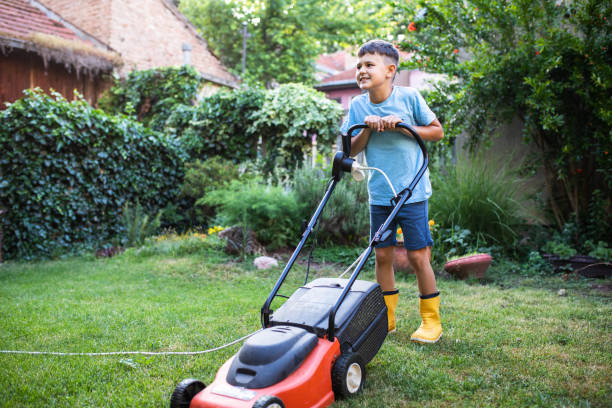 istock A cute boy happy mowing the lawn 1408235358