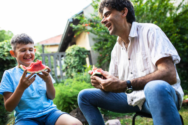 istock A cute boy eating watermelon 1408235384