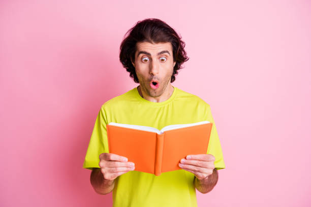 istock Photo of surprised funky young man look notebook read information unexpected isolated on pastel pink color background 1408236187