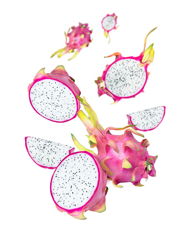 Dragon fruit (pitaya pitahaya) with cut half slice flying in the air isolated on white background.