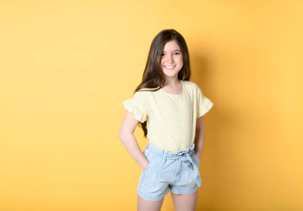 istock cute child over yellow background on studio 1408237566